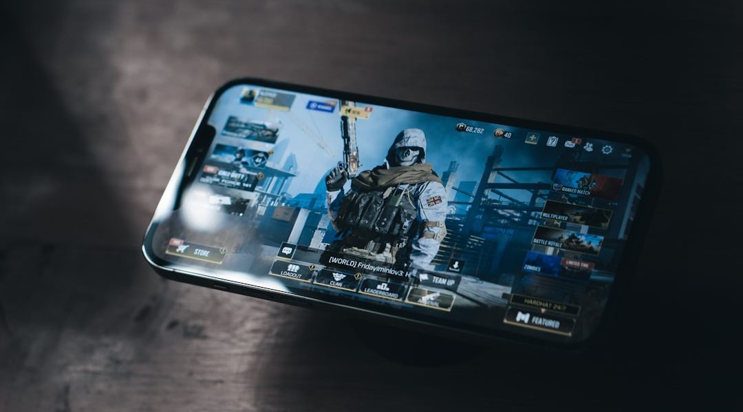 a person holding a cell phone with a video game on the screen