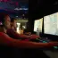 Two men playing video games on computers