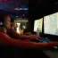 Two men playing video games on computers